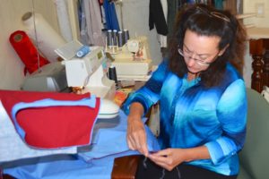 Phyllis Schmit working on a vest